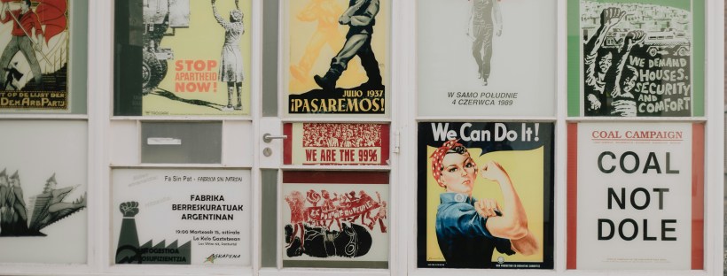 A wall with propaganda posters from several countries